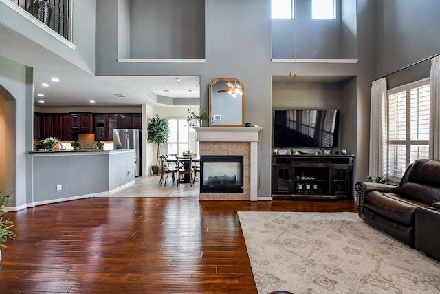 8423 Glenn Leigh Dr NE, Spring, TX 77379 - living area with a towering ceiling, dark wood-style floors, a fireplace, recessed lighting, and baseboards