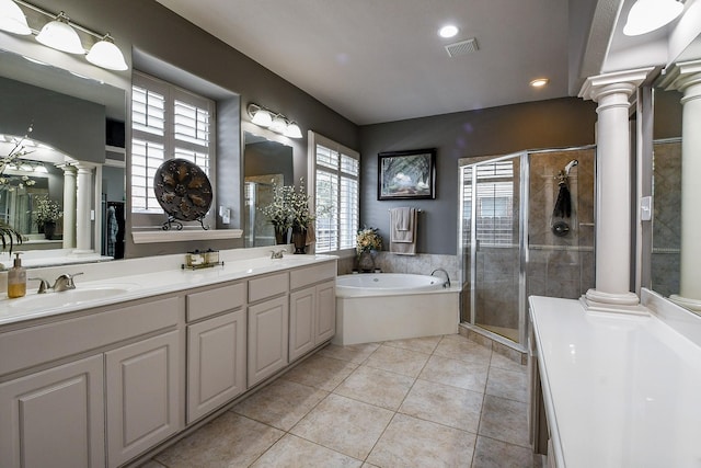 8423 Glenn Leigh Dr NE, Spring, TX 77379 - bathroom with decorative columns, a bath, a stall shower, double vanity, and tile patterned flooring