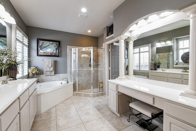 8423 Glenn Leigh Dr NE, Spring, TX 77379 - bathroom with decorative columns, a shower stall, a garden tub, two vanities, and recessed lighting