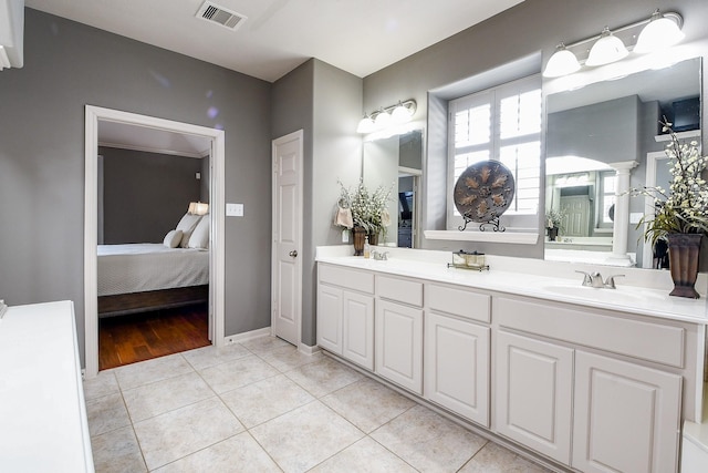 8423 Glenn Leigh Dr NE, Spring, TX 77379 - ensuite bathroom with double vanity, tile patterned flooring, and baseboards