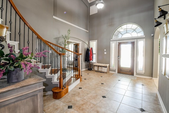 8423 Glenn Leigh Dr NE, Spring, TX 77379 - foyer entrance with a high ceiling, baseboards, stairs, and light tile patterned floors
