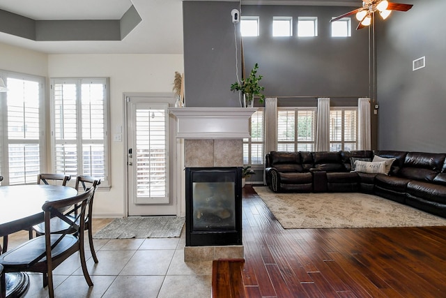 8423 Glenn Leigh Dr NE, Spring, TX 77379 - living area with ceiling fan, a tile fireplace, and wood finished floors