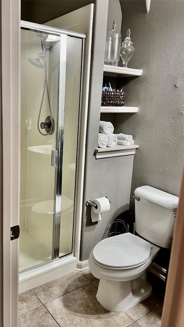 8423 Glenn Leigh Dr NE, Spring, TX 77379 - full bathroom featuring tile patterned floors, toilet, and a stall shower