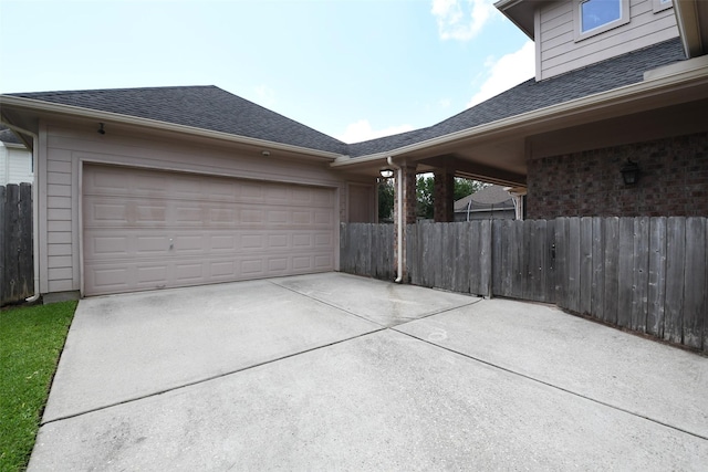 8423 Glenn Leigh Dr NE, Spring, TX 77379 - view of side of property featuring driveway, a shingled roof, and an attached garage