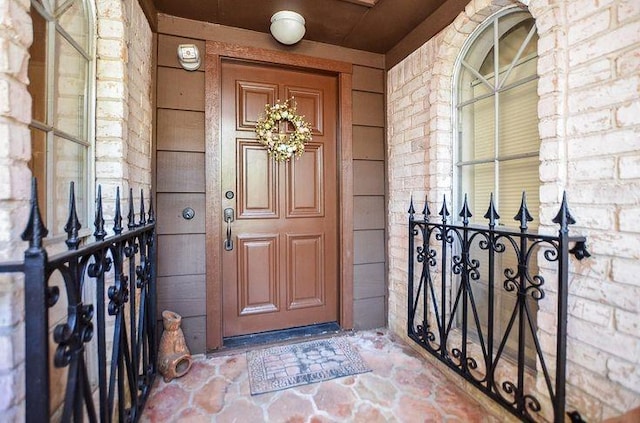 9719 Lawngate Dr, Houston, TX 77080 - doorway to property featuring covered porch and brick siding