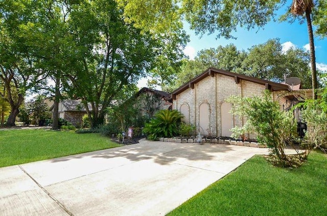 9719 Lawngate Dr, Houston, TX 77080 - view of front of house featuring a front lawn, stone siding, and concrete driveway