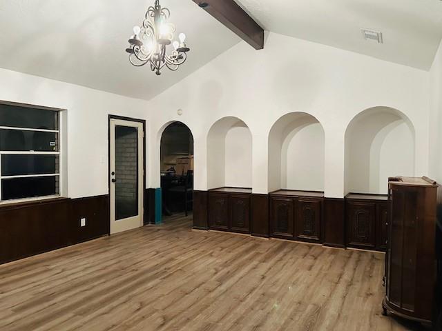 9719 Lawngate Dr, Houston, TX 77080 - unfurnished dining area featuring light wood-type flooring, a chandelier, and a wainscoted wall