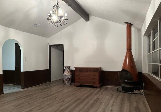 9719 Lawngate Dr, Houston, TX 77080 - living room with wood finished floors, a chandelier, and arched walkways