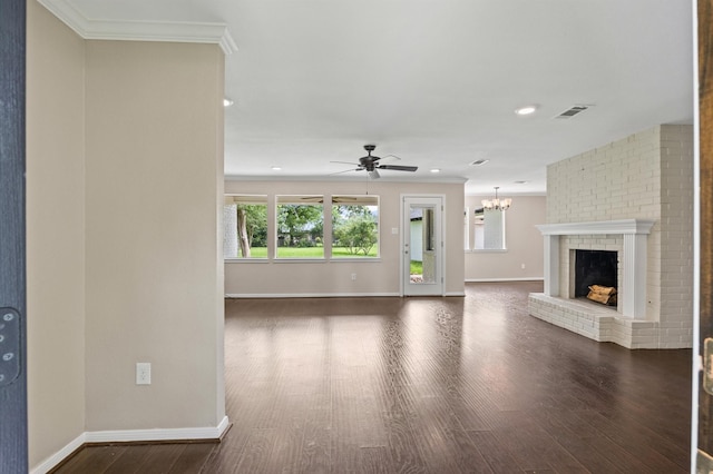 15414 Ashburton Dr, Jersey Village, TX 77040 - unfurnished living room with dark wood-type flooring, ceiling fan, crown molding, a chandelier, and a fireplace