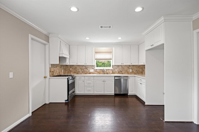 15414 Ashburton Dr, Jersey Village, TX 77040 - kitchen with stainless steel appliances, tasteful backsplash, light countertops, white cabinets, and premium range hood