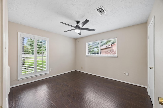 15414 Ashburton Dr, Jersey Village, TX 77040 - unfurnished room featuring a ceiling fan, dark wood finished floors, and a textured ceiling