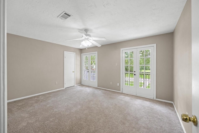15414 Ashburton Dr, Jersey Village, TX 77040 - carpeted empty room with french doors, a ceiling fan, and a textured ceiling