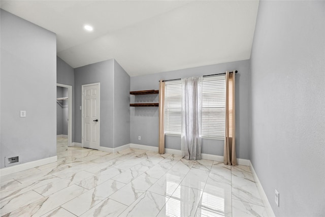 4130 Tree Moss Pl, Humble, TX 77346 - unfurnished bedroom featuring vaulted ceiling, marble look tiles, and baseboards