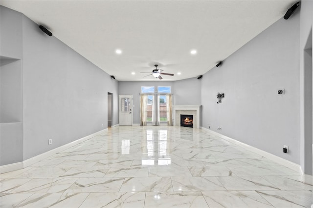 4130 Tree Moss Pl, Humble, TX 77346 - unfurnished living room with light marble finish floors, a ceiling fan, a high end fireplace, recessed lighting, and baseboards