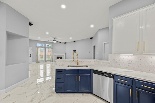4130 Tree Moss Pl, Humble, TX 77346 - kitchen featuring stainless steel dishwasher, a sink, light marble finish floors, open floor plan, and blue cabinetry