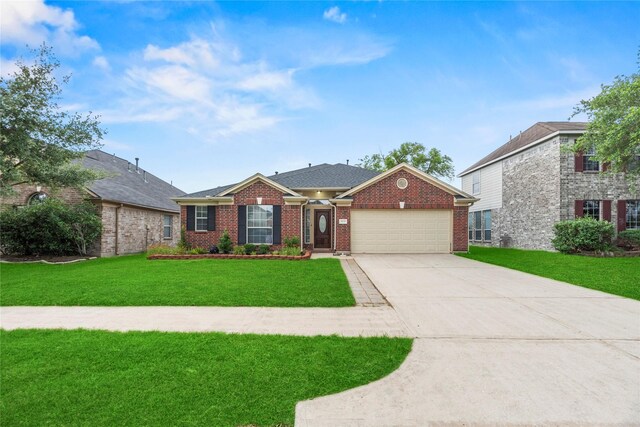 4130 Tree Moss Pl, Humble, TX 77346 - view of front of house with a garage, brick siding, a front lawn, and driveway