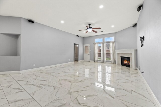 4130 Tree Moss Pl, Humble, TX 77346 - unfurnished living room featuring marble finish floors, ceiling fan, recessed lighting, a glass covered fireplace, and baseboards
