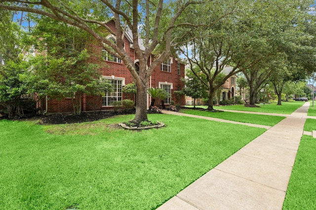 9607 Woodcliff Lake Dr, Spring, TX 77379 - view of front of home featuring a front yard and brick siding