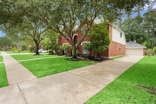 9607 Woodcliff Lake Dr, Spring, TX 77379 - view of front of home with brick siding, a front yard, a detached garage, and an outdoor structure
