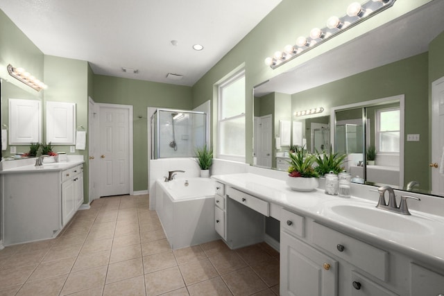 9607 Woodcliff Lake Dr, Spring, TX 77379 - full bath featuring a stall shower, two vanities, a bath, and tile patterned floors
