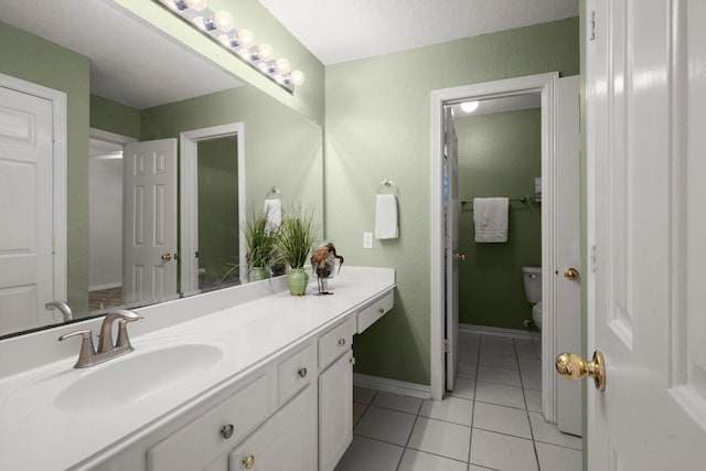 9607 Woodcliff Lake Dr, Spring, TX 77379 - full bathroom with vanity, tile patterned flooring, toilet, and baseboards