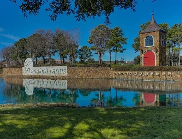9607 Woodcliff Lake Dr, Spring, TX 77379 - community / neighborhood sign featuring a water view and a lawn