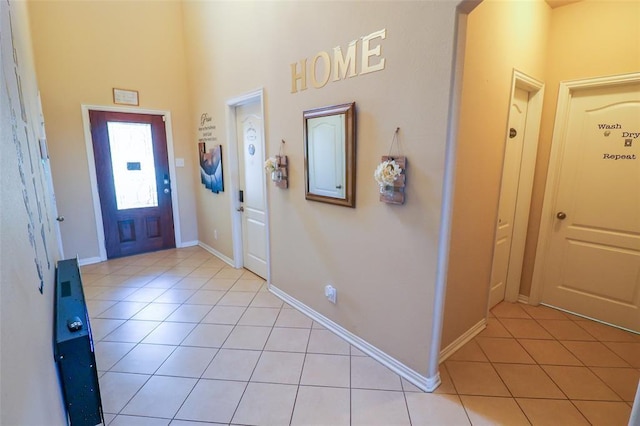 9911 Clear Diamond Dr, Rosharon, TX 77583 - entrance foyer with light tile patterned floors, baseboards, a high ceiling, and arched walkways
