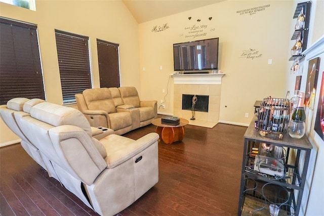9911 Clear Diamond Dr, Rosharon, TX 77583 - living area featuring vaulted ceiling, dark wood-style flooring, and a tile fireplace