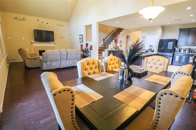 9911 Clear Diamond Dr, Rosharon, TX 77583 - dining space with stairway, wood finished floors, recessed lighting, and lofted ceiling