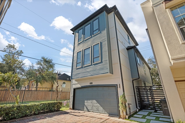 3414 Cline St, Houston, TX 77020 - view of front of home featuring a garage, driveway, and stucco siding