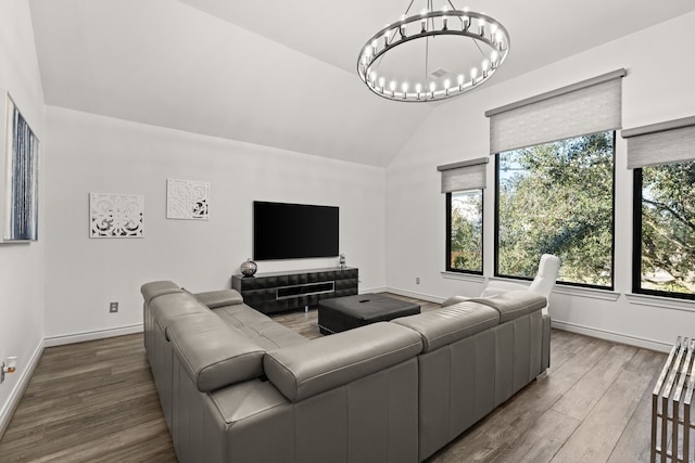 3414 Cline St, Houston, TX 77020 - living room featuring vaulted ceiling, a chandelier, wood finished floors, and baseboards