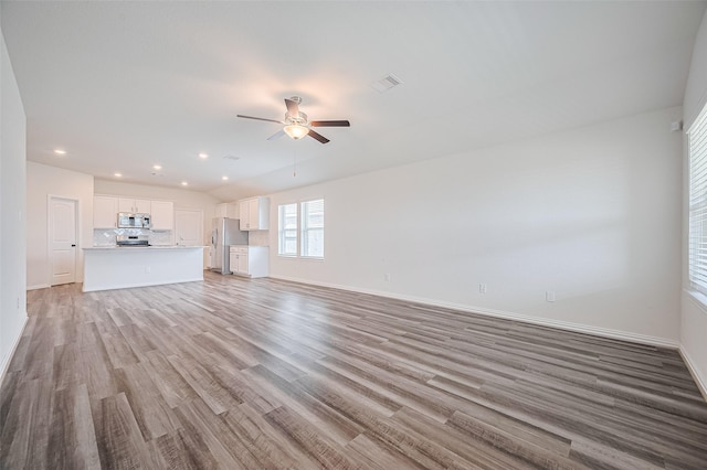 20231 Creekdale Bend Dr, Cypress, TX 77433 - unfurnished living room featuring light wood finished floors, ceiling fan, recessed lighting, and baseboards