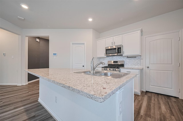 20231 Creekdale Bend Dr, Cypress, TX 77433 - kitchen featuring stainless steel appliances, dark wood finished floors, white cabinetry, backsplash, and a sink
