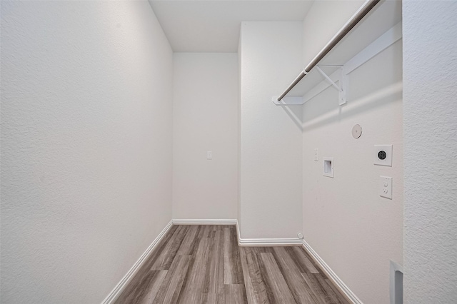 20231 Creekdale Bend Dr, Cypress, TX 77433 - laundry room featuring hookup for an electric dryer, hookup for a gas dryer, wood finished floors, washer hookup, and baseboards