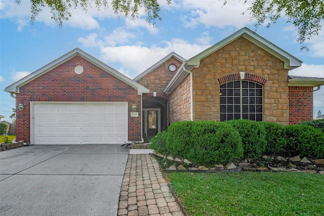 13409 Timberoak Ct, Rosharon, TX 77583 - view of front of home featuring stone siding, driveway, a garage, and brick siding