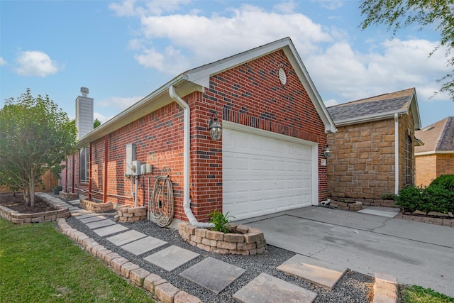 13409 Timberoak Ct, Rosharon, TX 77583 - view of home's exterior featuring a chimney, brick siding, concrete driveway, a garage, and stone siding