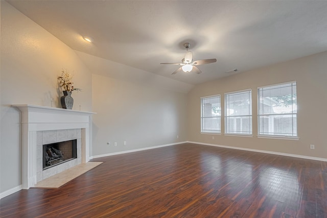 13409 Timberoak Ct, Rosharon, TX 77583 - unfurnished living room featuring ceiling fan, a tiled fireplace, dark wood-style flooring, baseboards, and lofted ceiling