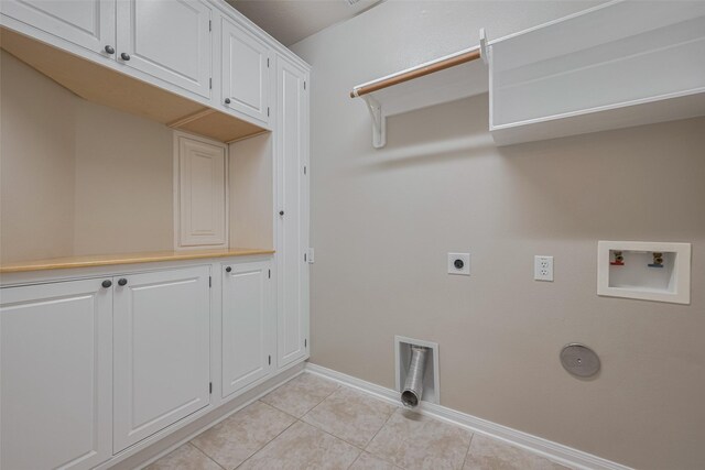 13409 Timberoak Ct, Rosharon, TX 77583 - washroom featuring electric dryer hookup, washer hookup, light tile patterned floors, baseboards, and cabinet space