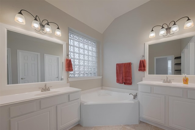 13409 Timberoak Ct, Rosharon, TX 77583 - bathroom with vaulted ceiling, two vanities, a garden tub, and tile patterned floors