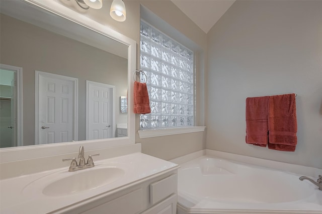 13409 Timberoak Ct, Rosharon, TX 77583 - full bathroom featuring a garden tub, vanity, and lofted ceiling