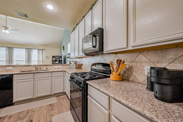 2927 Coachmaker Trl, Rosenberg, TX 77471 - kitchen featuring black appliances, a sink, light wood finished floors, tasteful backsplash, and light stone counters