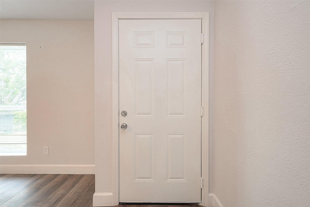 12111 Jutland Rd, Houston, TX 77048 - doorway with baseboards and wood finished floors