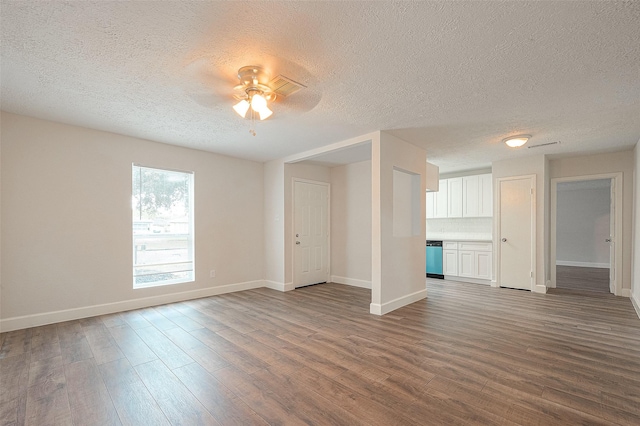 12111 Jutland Rd, Houston, TX 77048 - unfurnished living room featuring a textured ceiling, dark wood-style floors, baseboards, and a ceiling fan