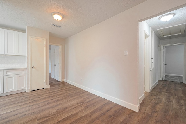 12111 Jutland Rd, Houston, TX 77048 - hall with attic access, wood finished floors, baseboards, and a textured ceiling