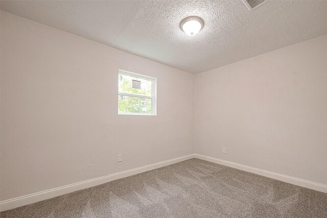 12111 Jutland Rd, Houston, TX 77048 - spare room featuring carpet, baseboards, and a textured ceiling