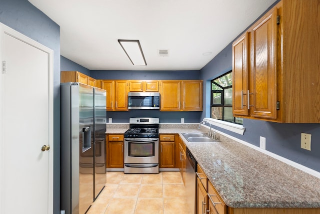 14 W Cobble Hill Cir, The Woodlands, TX 77381 - kitchen with appliances with stainless steel finishes, a sink, and brown cabinets