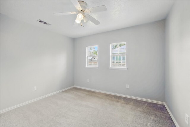 1118 Hammock St, Houston, TX 77009 - empty room featuring light colored carpet, baseboards, and ceiling fan