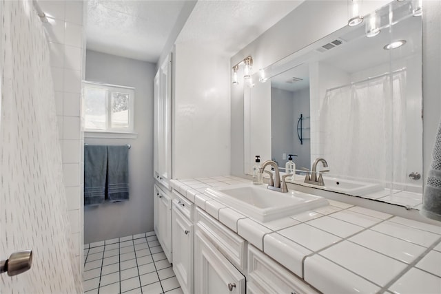 1118 Hammock St, Houston, TX 77009 - bathroom featuring vanity, tile patterned floors, and a textured ceiling