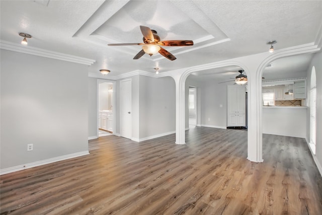 1118 Hammock St, Houston, TX 77009 - unfurnished living room featuring a ceiling fan, arched walkways, a textured ceiling, wood finished floors, and baseboards