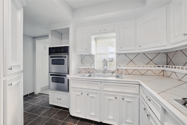 1118 Hammock St, Houston, TX 77009 - kitchen featuring a sink, stainless steel double oven, and white cabinets